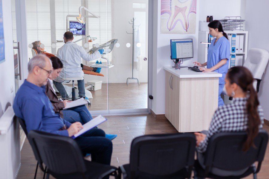 Patients waiting in the reception area while healthcare professionals provide treatment at a modern multi-speciality hospital in Paschim Vihar.