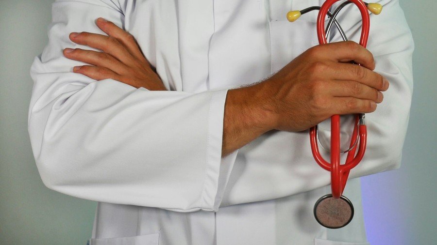 General physician in a white coat holding a stethoscope